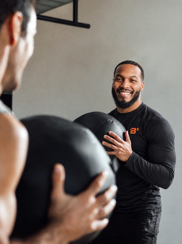 Duane coaching a client with a medicine ball at Brewster’s studio in Crouch End
