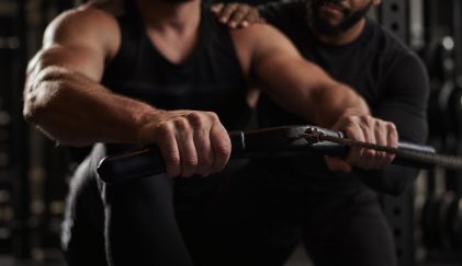 Duane coaching a client on the cable row