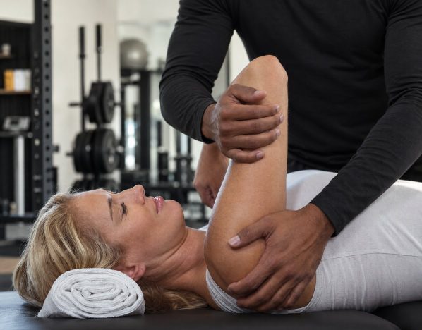 Duane giving a client an assisted shoulder stretch